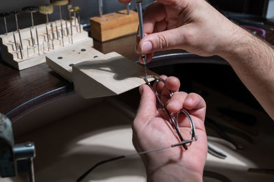 Midsection of person working on wood