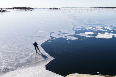 Person ice-skating on frozen water