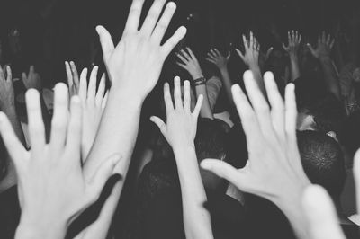 Crowd waving hands at concert