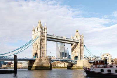 View of bridge over river against cloudy sky