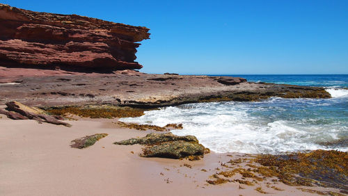 Scenic view of sea against clear blue sky