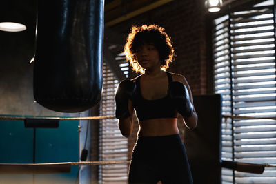 Rear view of woman standing by railing