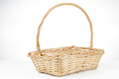 Close-up of wicker basket on white background