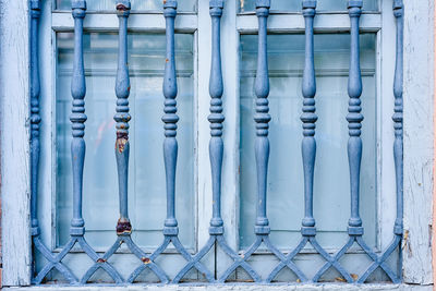 Close-up of metal fence against blue sky