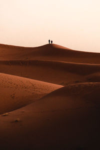 Lighthouse on desert against clear sky