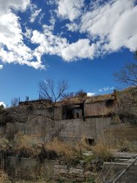 Built structure on landscape against sky