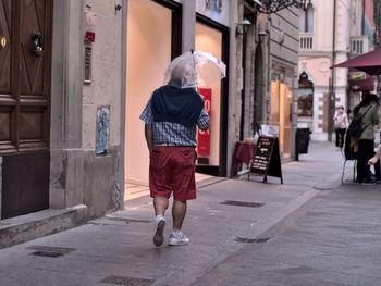 Rear view of woman walking on street