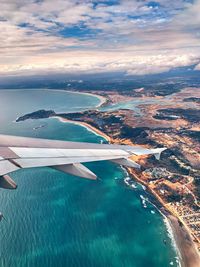 Aerial view of sea and mountains against sky