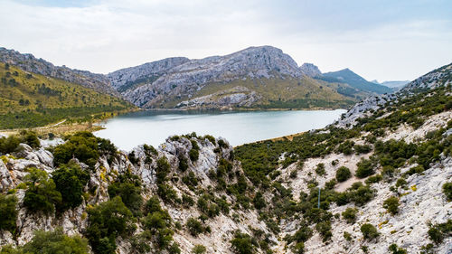 Scenic view of lake and mountains against sky