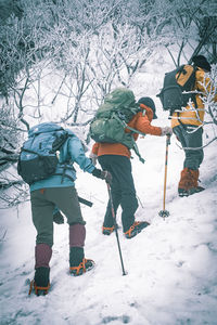 People standing on snow covered land