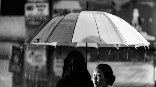 Rear view of people on wet rainy day