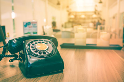 Close-up of rotary phone on table