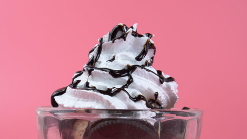 Close-up of ice cream against red background