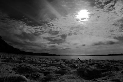 Scenic view of beach against cloudy sky