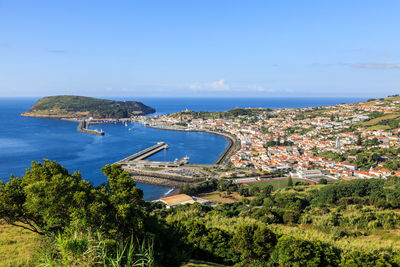 High angle view of buildings and sea against sky