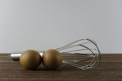 Close-up of eggs in container on table against white background