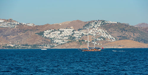 Sailboat sailing in sea against sky