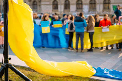 Protestors at anti-war rally holding national flag. people manifesting for ukraine.