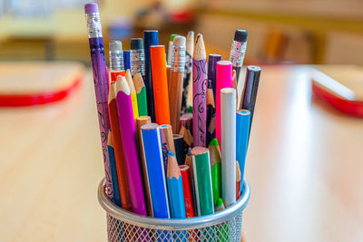 Close-up of multi colored pencils on table