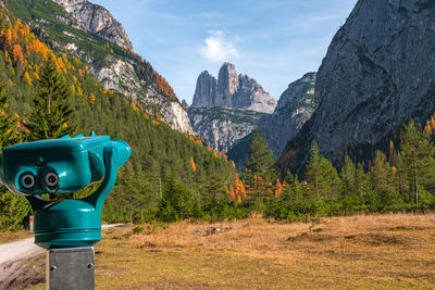 Green landscape with mountain range in background against sky