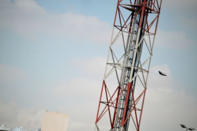 Low angle view of communications tower against sky