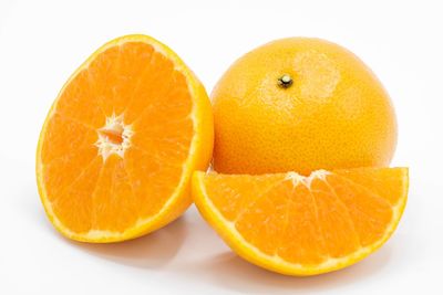 Close-up of orange fruit against white background