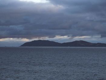 Scenic view of sea against cloudy sky