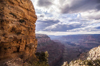 Scenic view of rocky mountains against cloudy sky