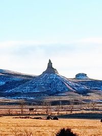 Built structure on snow covered field against sky