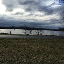 Scenic view of lake against cloudy sky