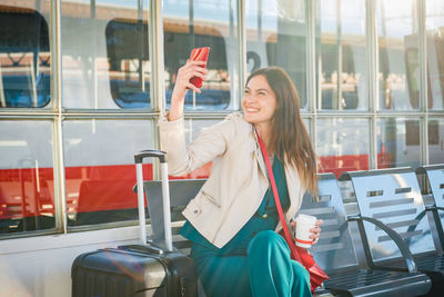 Portrait of young woman sitting in train