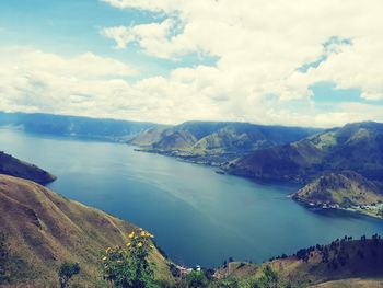 Scenic view of lake and mountains against sky