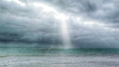 Scenic view of sea against storm clouds