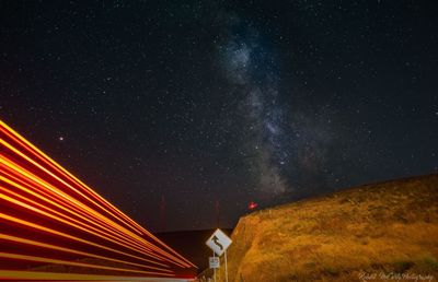Low angle view of illuminated building against sky at night