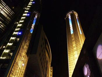 Low angle view of skyscrapers lit up at night