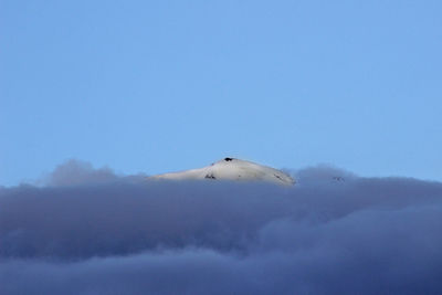 Scenic view of snowcapped mountain against cloudy sky