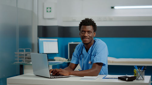 Portrait of smiling doctor in clinic