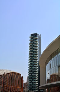 Low angle view of modern buildings against blue sky