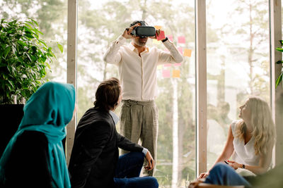 Businessman wearing virtual reality simulator during conference at convention center