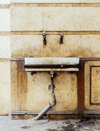 Abandoned sink on weathered wall