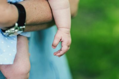 Midsection of father holding baby