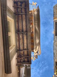 Low angle view of sculptures on building against sky