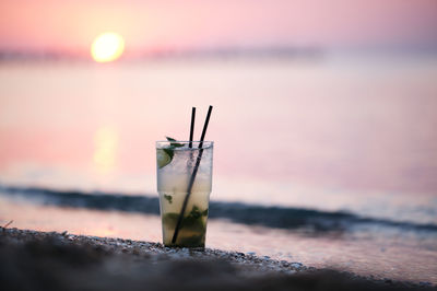 Close-up of boat in sea at sunset