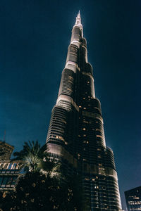 Low angle view of skyscrapers lit up at night