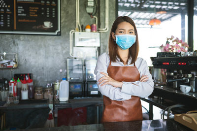 Portrait of woman standing in restaurant