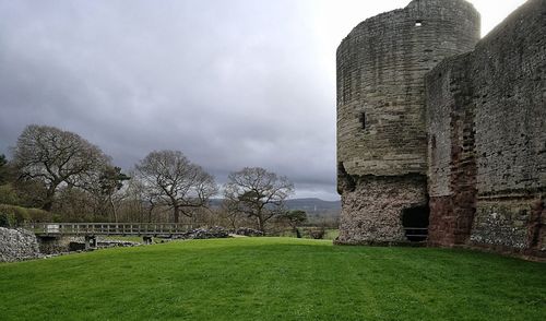 Built structure in grass against sky