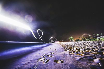 Scenic view of beach against sky at night