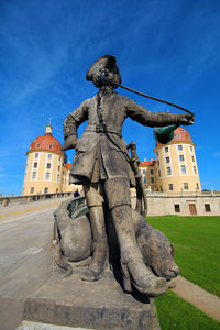 Statue of historic building against blue sky