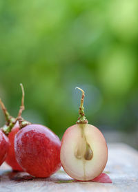 Close-up of red grapes on table outdoors