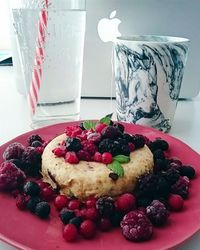 Close-up of red cherries on plate